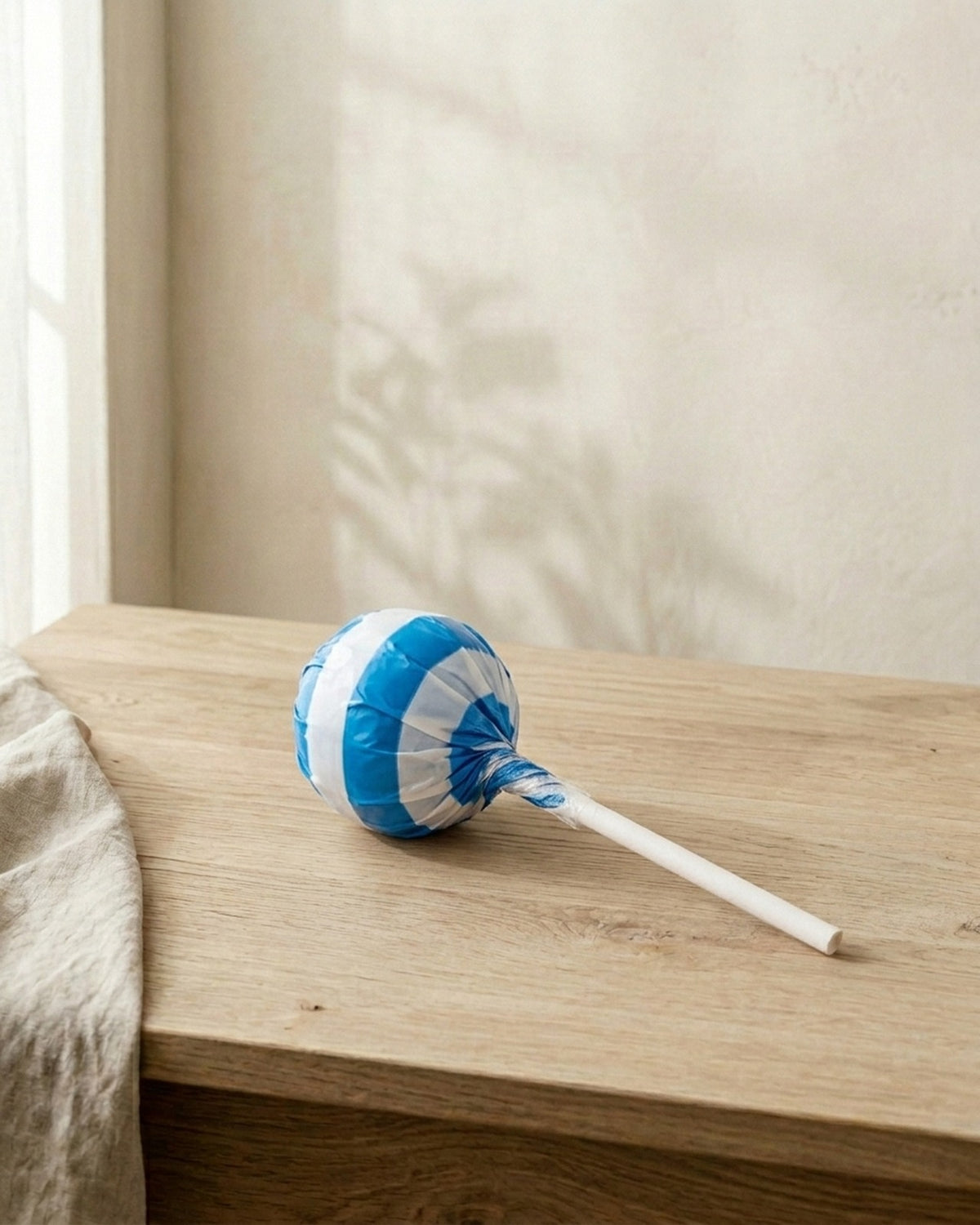 A sugar-free lollipop in a blue and white wrapper