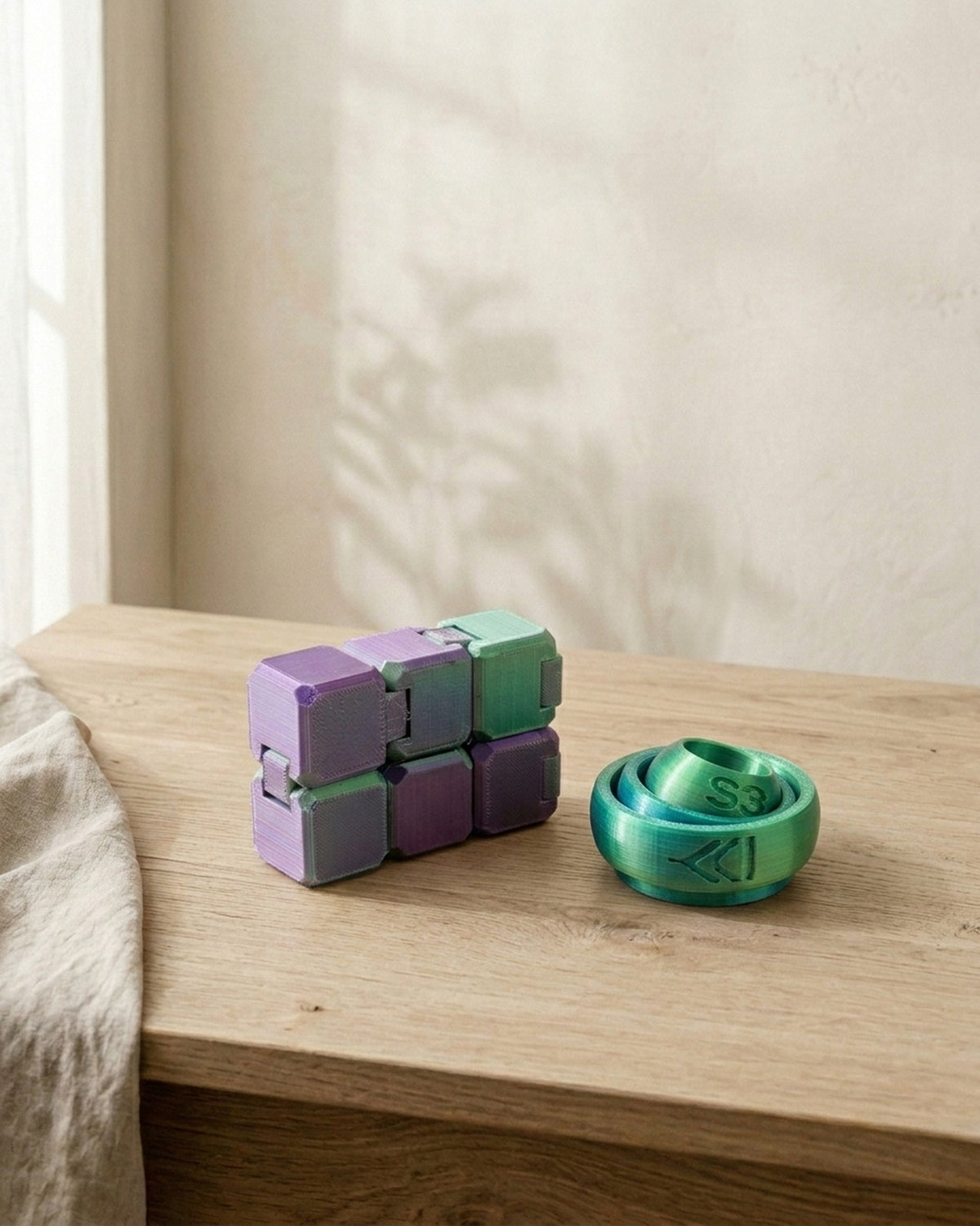 Two PLA fidgets: an infinity cube and a ring fidget