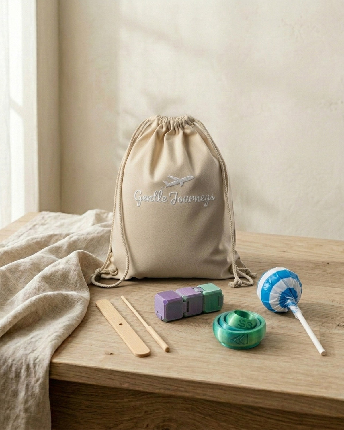 Natural Eco sensory travel bag with the bamboo flyer, two PLA fidgets and a lollipop