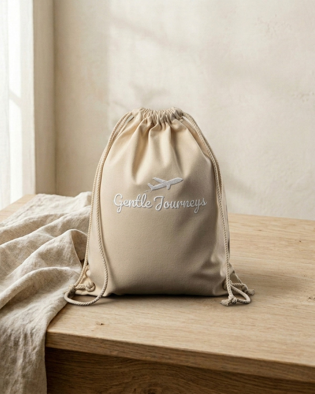 Natural Eco sensory travel bag, front view with the embroidered Gentle Journeys logo