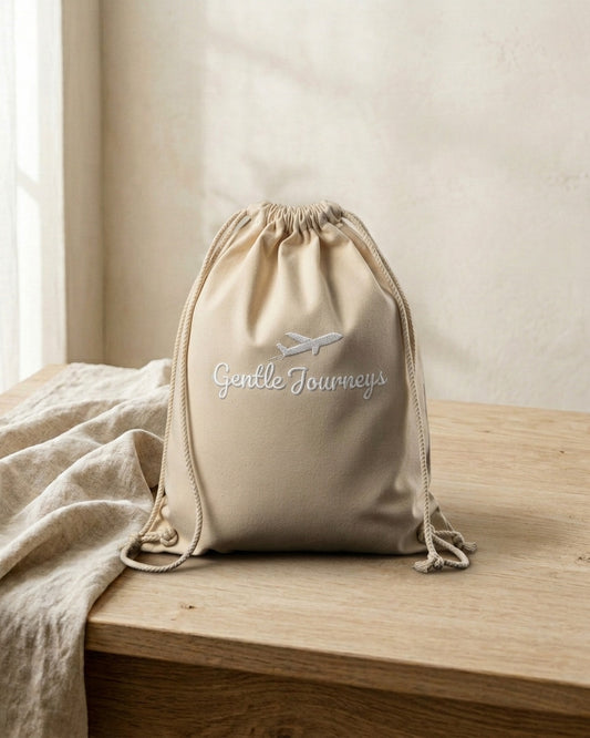 Natural Eco sensory travel bag, front view with the embroidered Gentle Journeys logo
