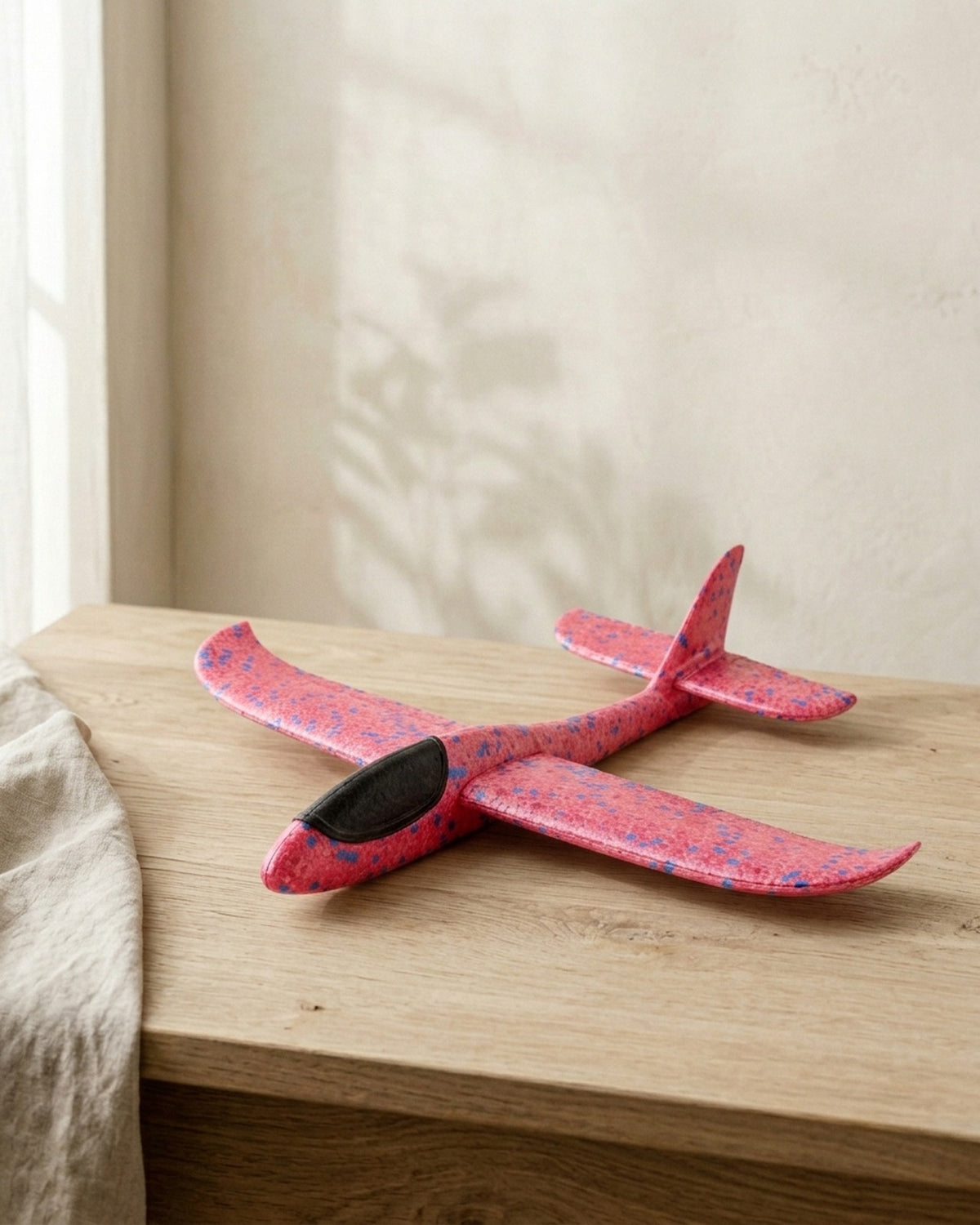 The pink speckled foam glider plane