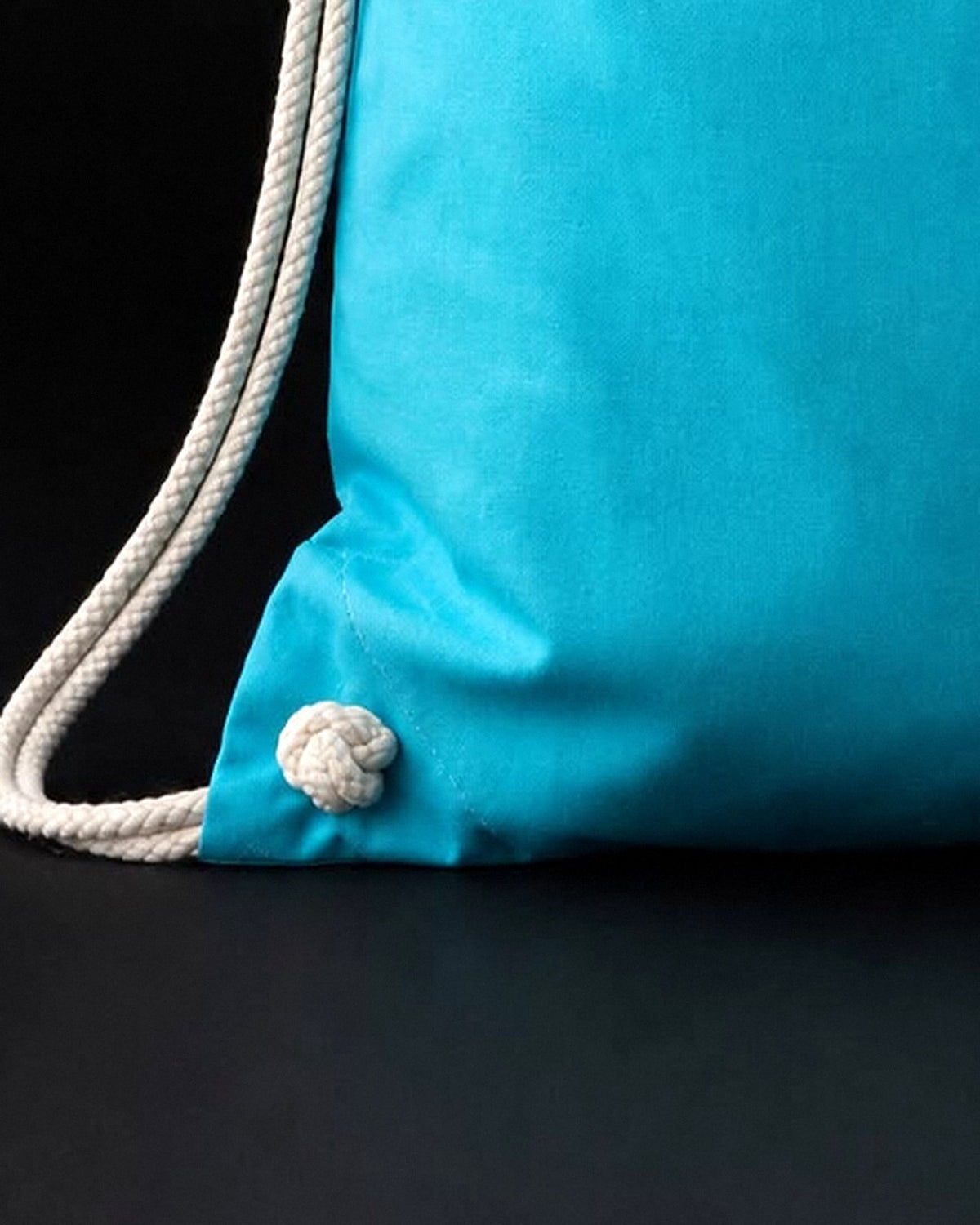 Close-up of the white soft cotton cords on the blue Soft Cotton sensory travel bag