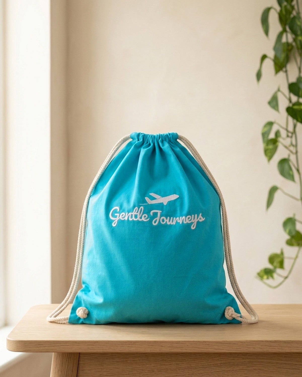 Blue Soft Cotton sensory travel bag, front view with the embroidered Gentle Journeys logo
