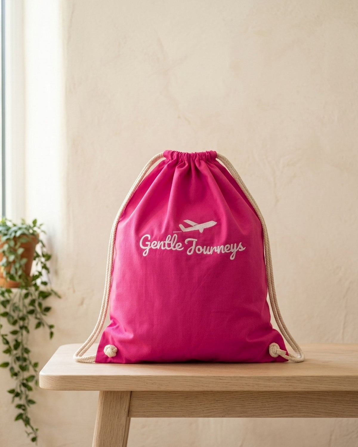 Pink Soft Cotton sensory travel bag, front view with the embroidered Gentle Journeys logo