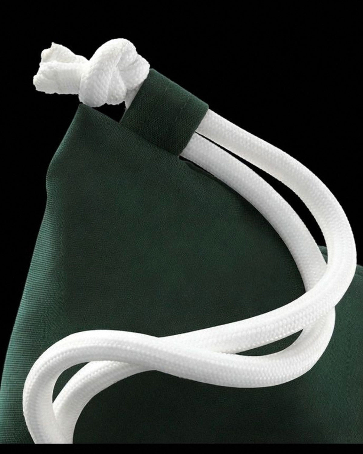 Close-up of the thick white nylon cords on the green Water-Resistant sensory travel bag