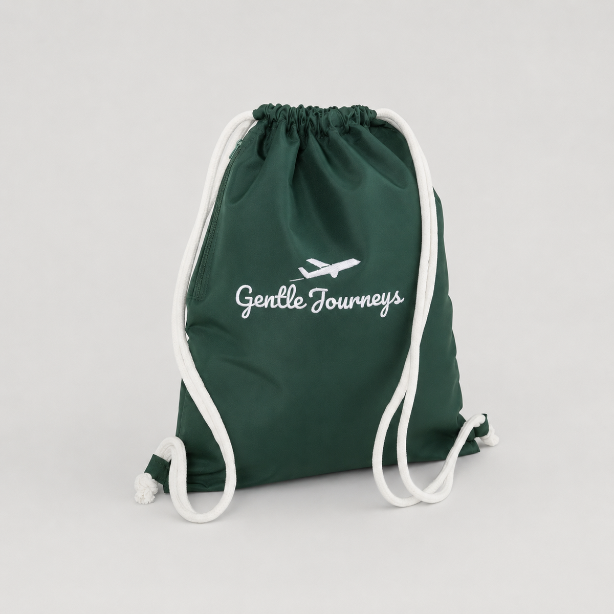 Green water-resistant sensory bag at an angle, showing the side zip pocket and white drawstring straps